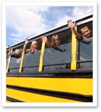 children waving from bus window