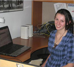 female student sitting at a desk with a computer