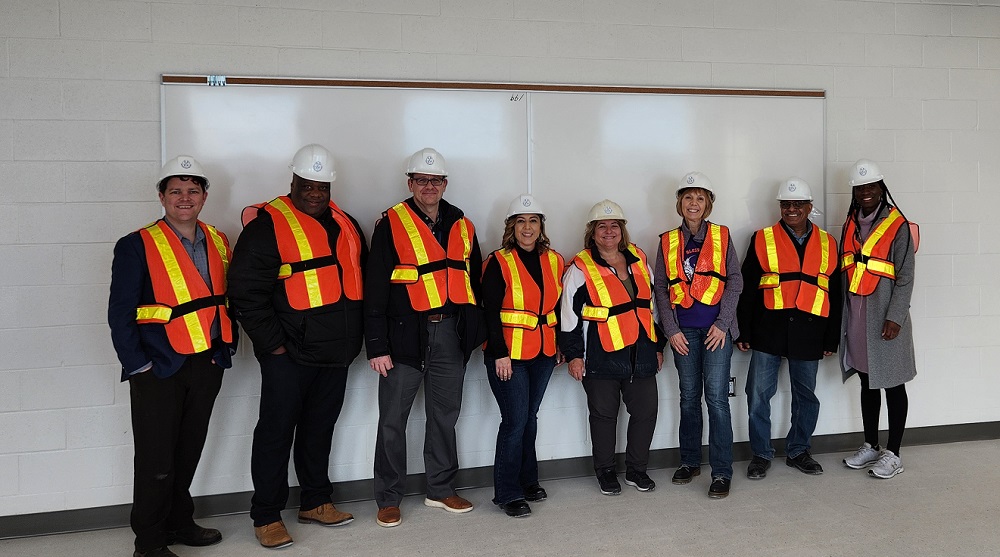 From left to right: Mark Brosens, Senior Manager: Brand, Marketing and Communications; Joel Chiutsi, Superintendent of Education; Dan Bruni, Principal of St. Katharine Drexel CHS; Jennifer Wigston, Trustee; Elizabeth Crowe, Chair of the Board of Trustees; Mireille Walter, Principal of Blessed Chiara Badano CES; Khaled Elgharbawy, Superintendent of Facilities Services and Plant; Siobhan Wright, Superintendent of Education