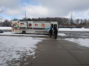 Students boarding the Tour for Humanity mobile classroom