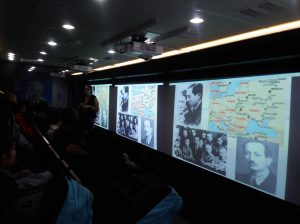 Information is displayed on a screen in the Tour for Humanity classroom