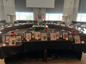 Staff at the Catholic Education Centre displays photos and stories of family members who served and continues to serve Canada