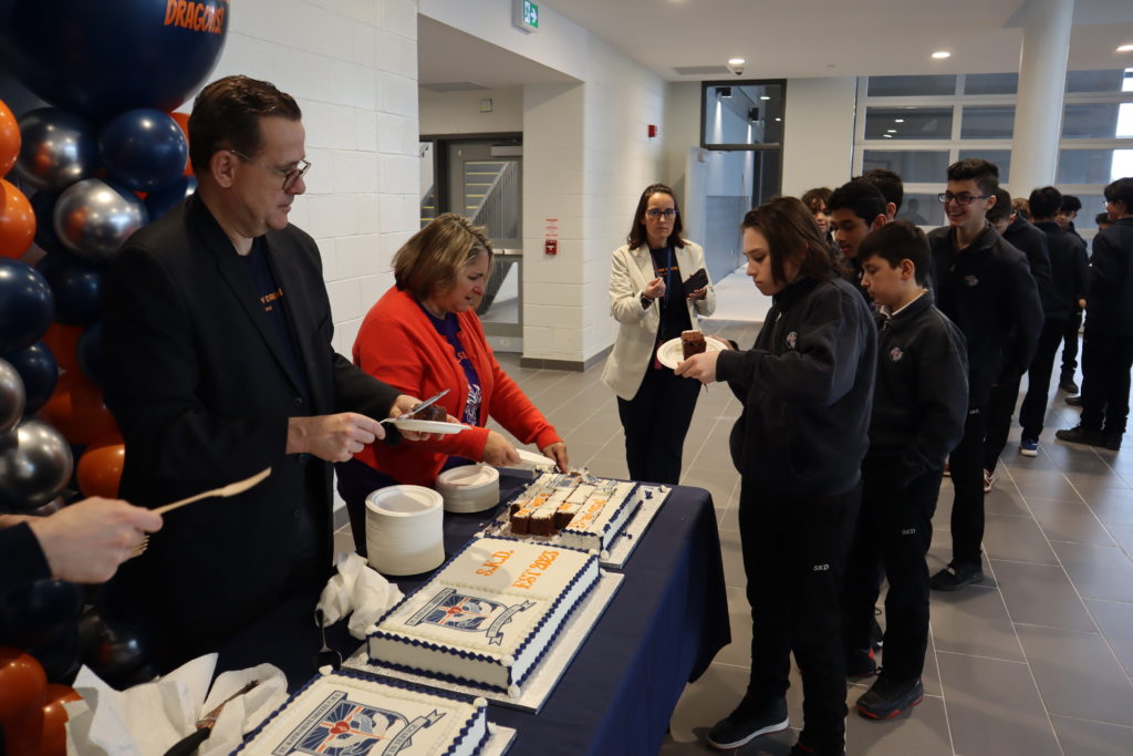 St. Katharine Drexel CHS students are served cake by YCDSB Chair Elizabeth Crowe and Principal Dan Bruni.