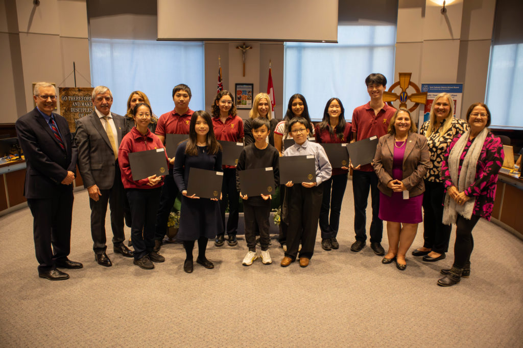 A photo of: The following students won medals at the York Region Science and Technology Fair: Aashika Maram Reddy of Cardinal Carter CHS (bronze); James So and Jessica Lo of St. Augustine CHS (bronze); Tina Nasiri-Toosi and Chloe Fu of St. Augustine CHS (bronze); Terry Xiao and Matthew Siu of St. Augustine CHS (gold); Nicholas Ching and Albert Liao of St. Augustine CHS (silver); Charles Tam and Haygen Lin of St. Justin Martyr CES (silver); Clara Fu of St. Augustine CHS (silver); Candace Hon of St. Justin Martyr CES (silver); Tyler Mo of St. Justin Martyr CES (silver); Nima Vasigh and Ian Patrick Tan of St. Robert CHS (silver).Pictured in the YCDSB Boardroom with members of the Board of Trustees 