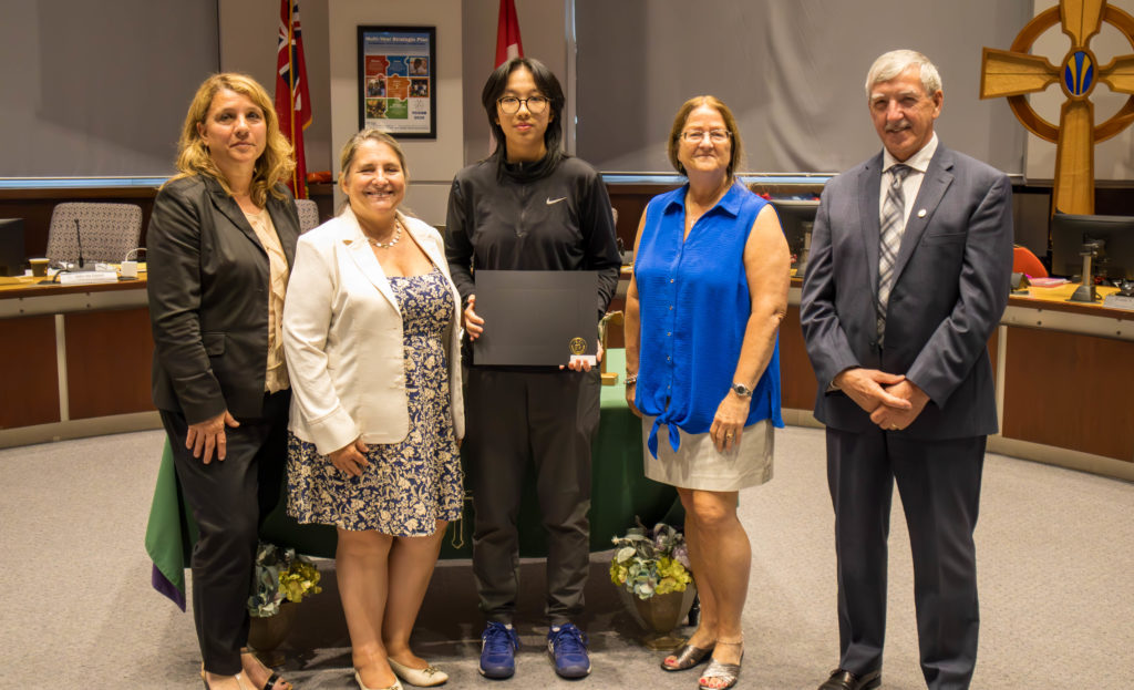 A photo of: Ada Huang of St. Robert CHS won a silver medal for OFSAA Senior Tennis. Pictured in the YCDSB Boardroom with members of the Board of Trustees. 
