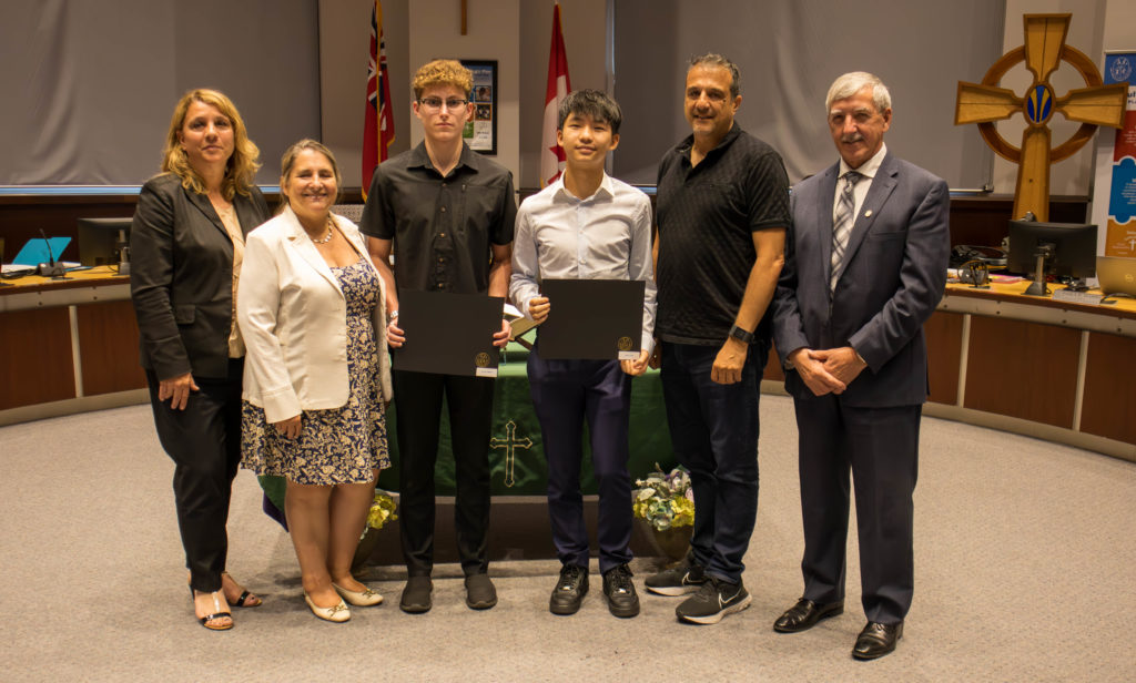 A photo of: Daniel Chernin of St. Theresa of Lisieux CHS won a silver medal for OFSAA 100M Boys Backstroke Swimming. And Aidan Tong of St. Theresa of Lisieux CHS won a silver medal for OFSAA junior boys 50m backstroke swimming. Pictured in the YCDSB Boardroom with members of the Board of Trustees. 