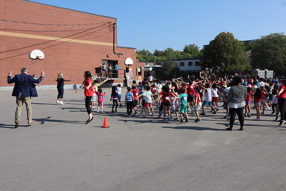 Students, staff and dignitaries stretch before the Terry Fox run/walk/roll outside behind St. Patrick CES Markham.