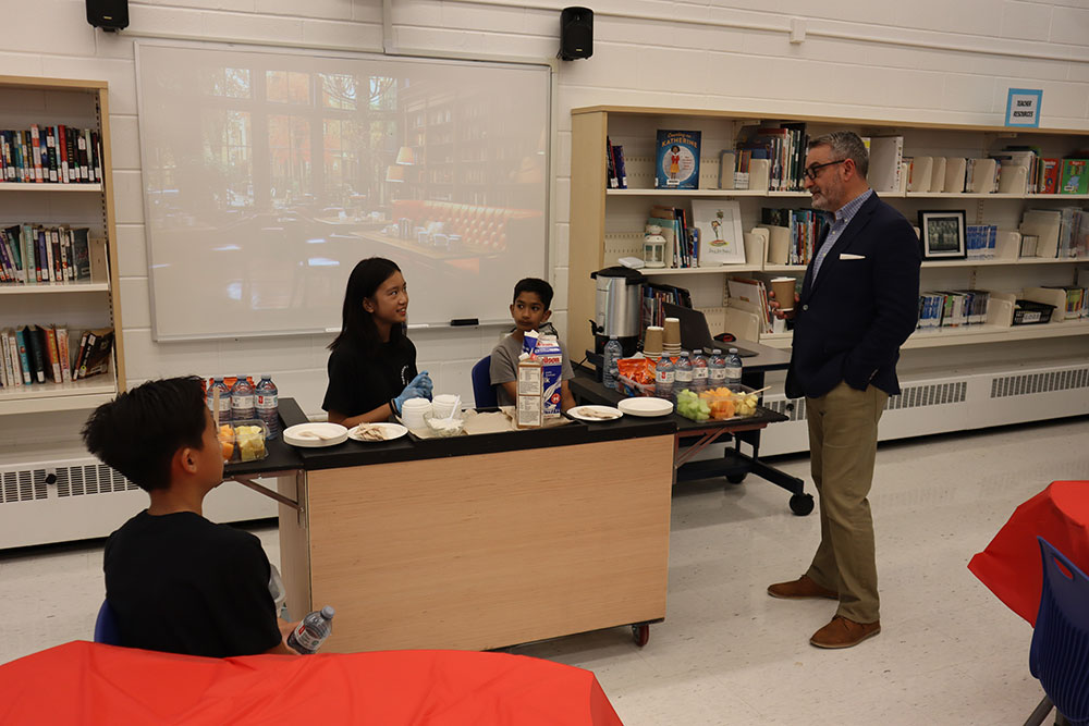 Minister Calandra speaks with St. Patrick CES Markham students in the library of the school. 