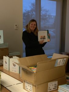 A teacher picking out books for her class