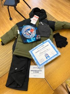 A snowsuit and a certificate for members of the Challenger Baseball Program