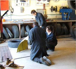 3 students working in auto shop