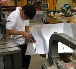 student working in metal shop